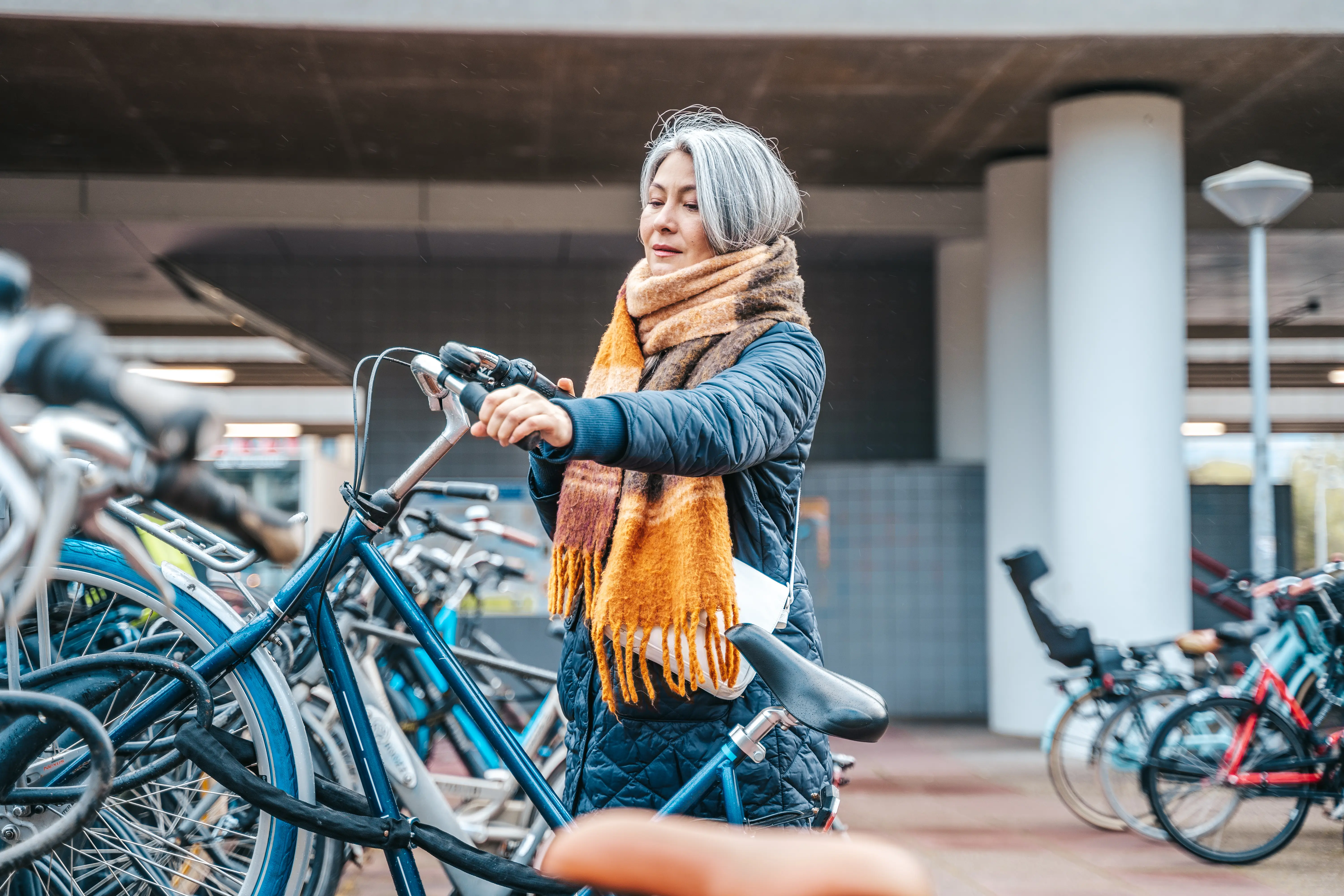 Senior woman gets bike parking